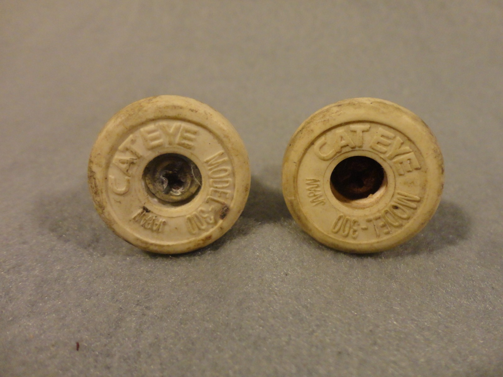 Cateye handlebar plugs, old, originally white, slightly yellowed w/ age
