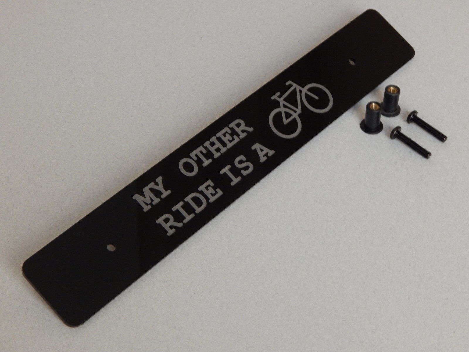 Front license plate delete black acrylic laser engraved with: My Other Ride Is A