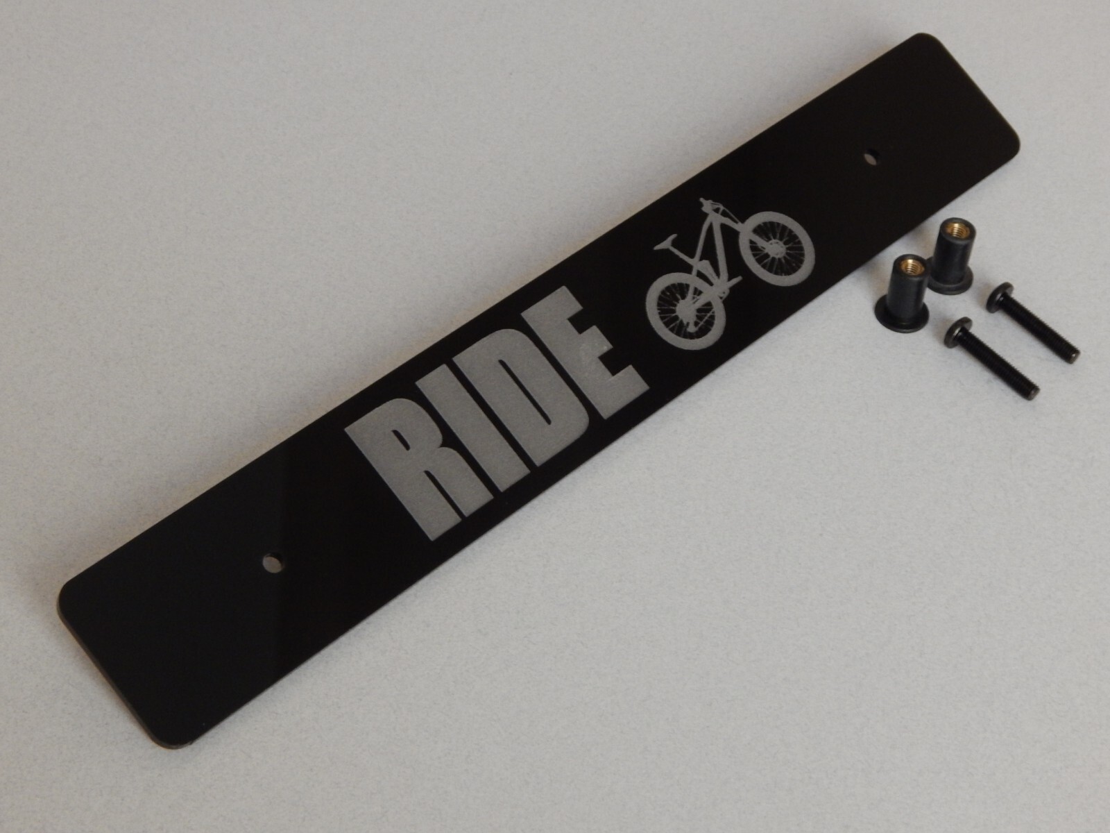 Front license plate delete black acrylic laser engraved with: RIDE (mtb bike)