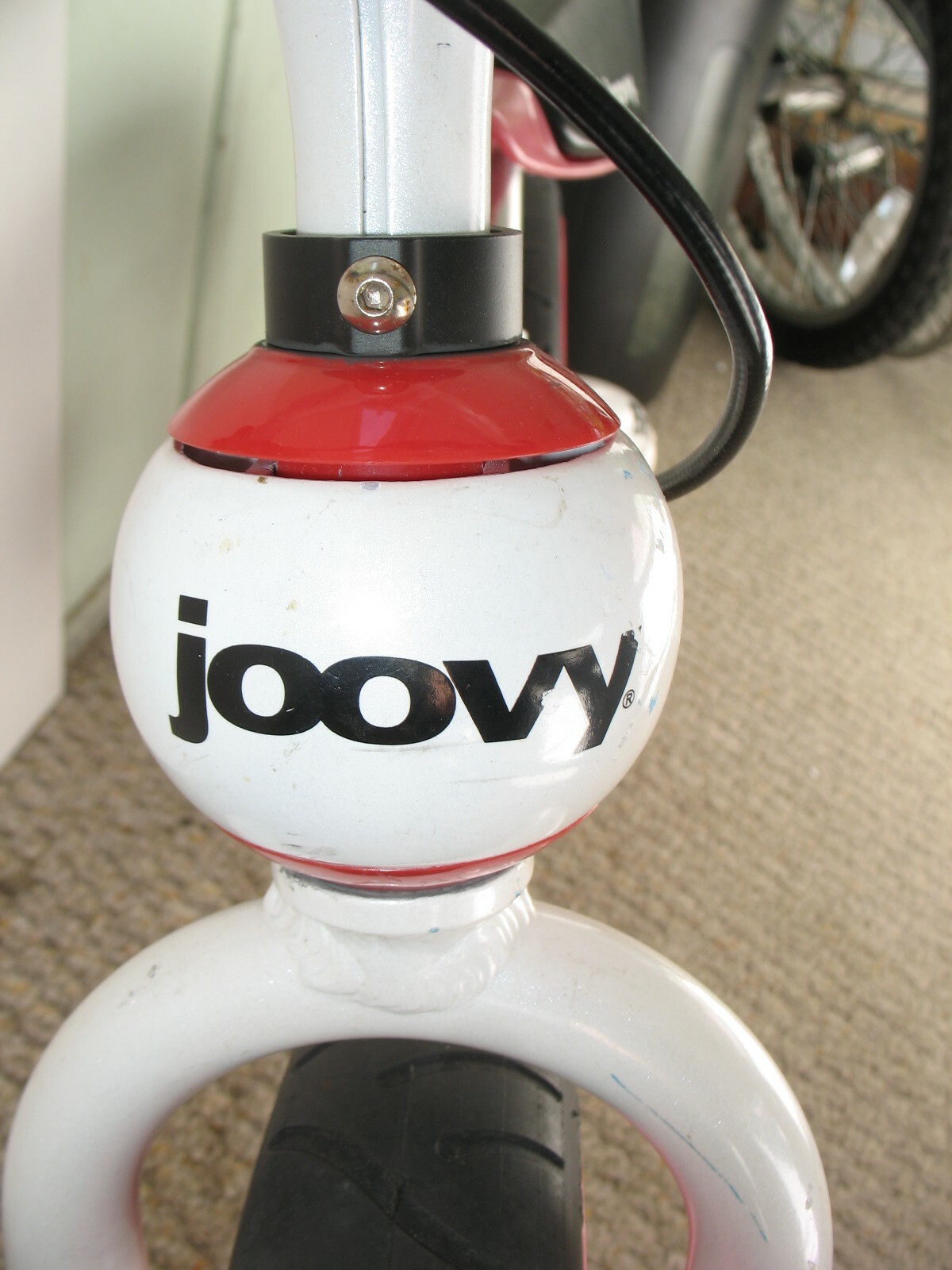 Red Bottom Head Set Cover from a Joovy Bicycoo Balance Bike