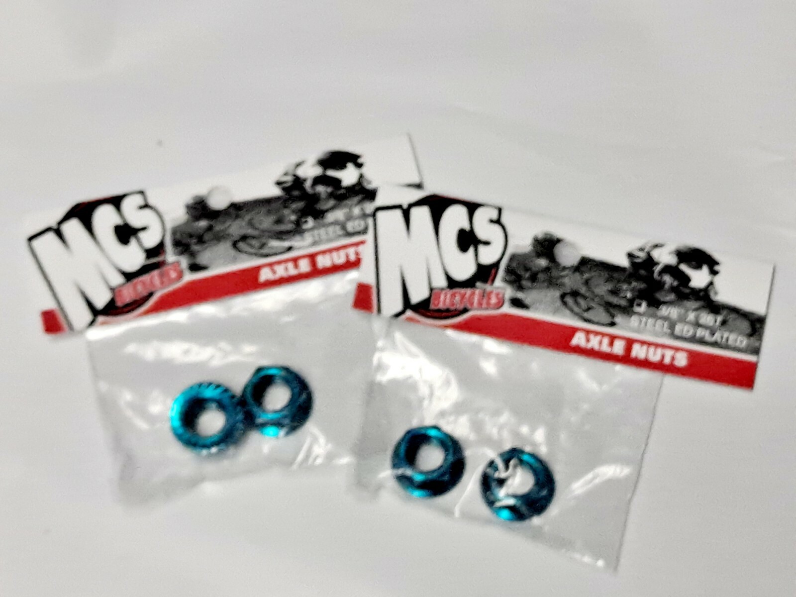 MCS Blue Chromoly Flanged Axle Nuts 3/8″x26t Set of 4